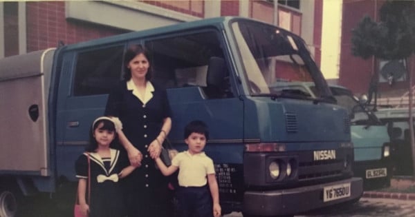 Family taking picture in front of a van